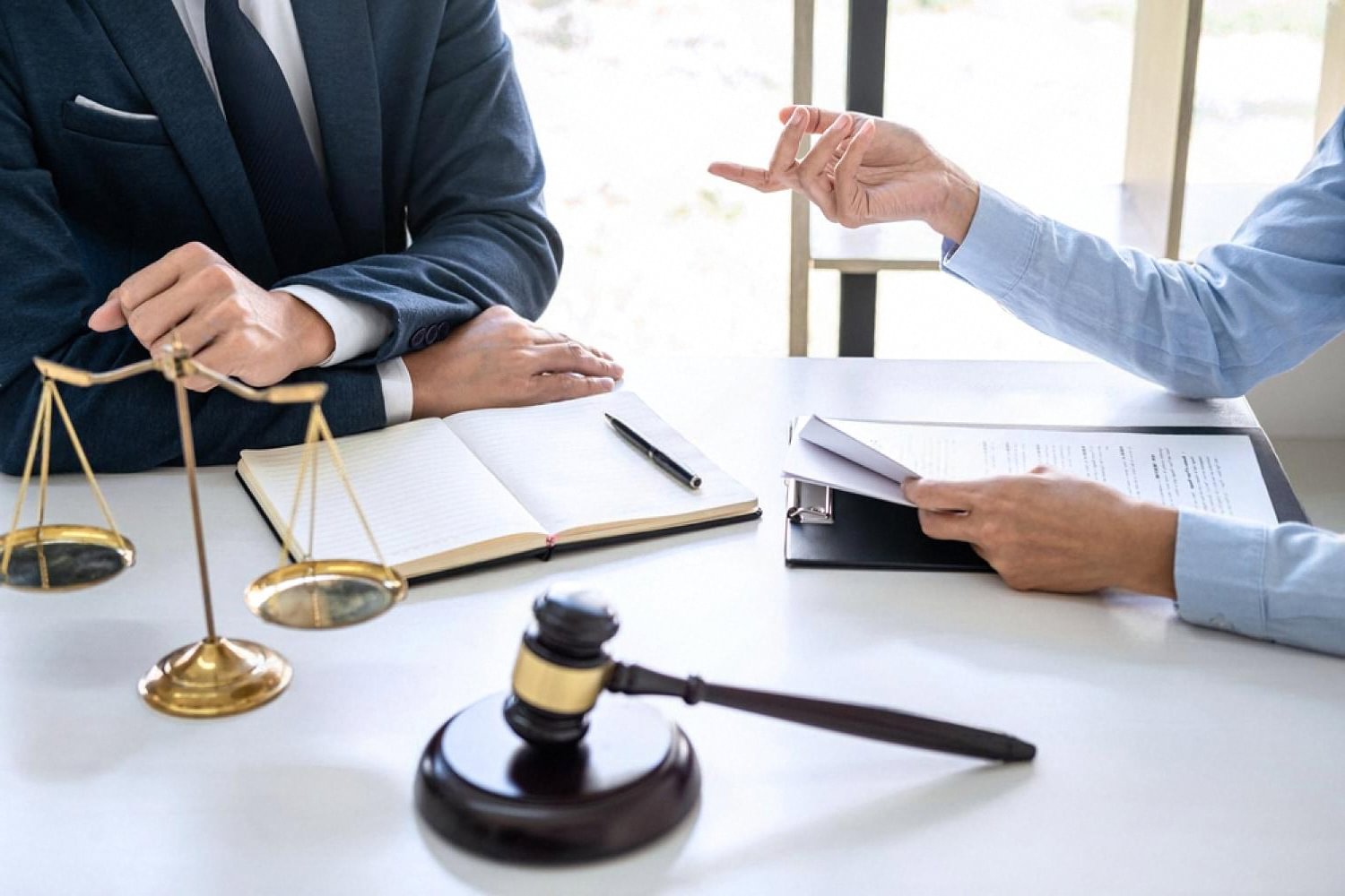 Commercial lawyer reviewing a supplier contract dispute with a client in the UAE